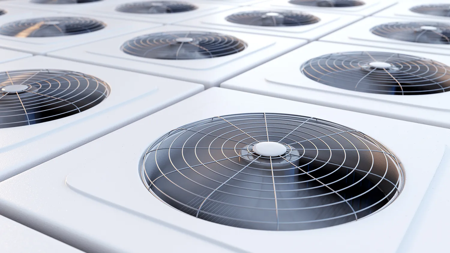 Keene Marketing Agency Close-up of multiple industrial air conditioning units with large fans housed in circular grates on a building's roof.