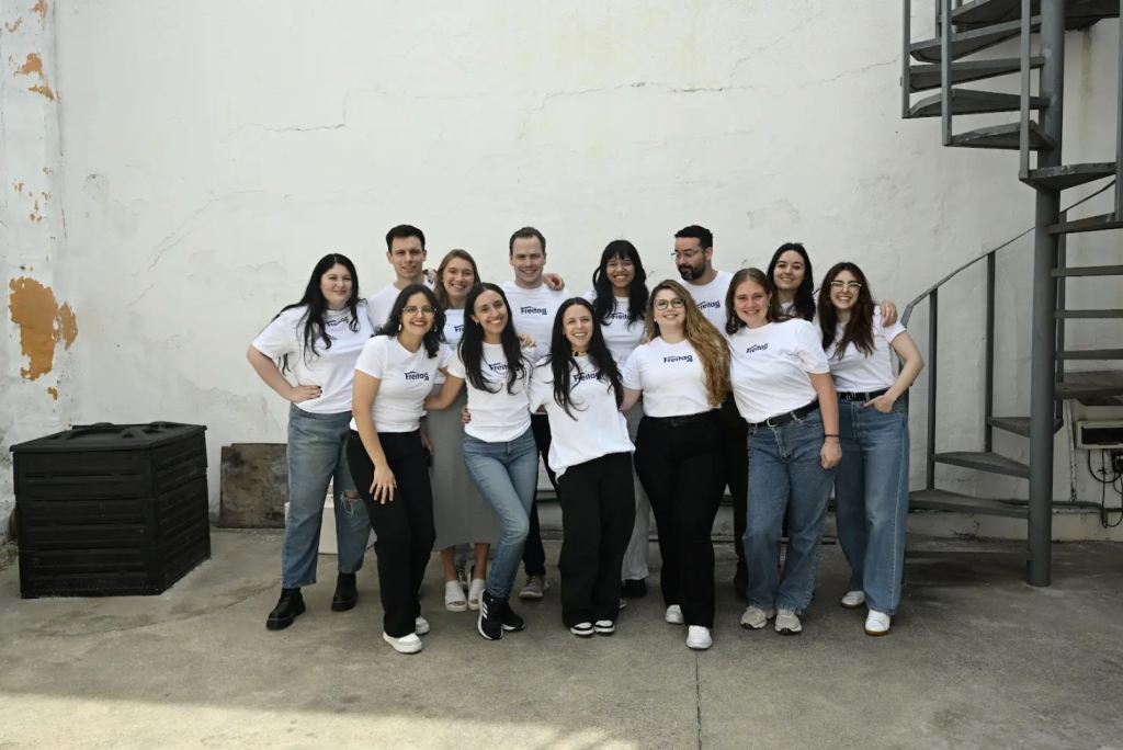 New Hampshire A group of 14 people, representing some of the top marketing agencies in New Hampshire, stand outside wearing matching white T-shirts and casual pants. They're posing confidently in front of a plain wall and a striking spiral staircase. Marketing Agency