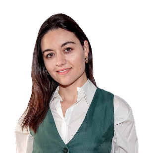 New Hampshire A young woman with straight brown hair wearing a white collared shirt and a green vest, standing and smiling at the camera against a white background. Marketing Agency