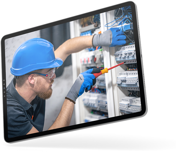 New Hampshire A person wearing a blue hard hat and gloves uses a screwdriver on electrical panels inside an open cabinet. Marketing Agency