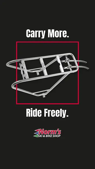 New Hampshire A silver bike rack is centered on a black background with the text "Carry More. Ride Freely." and Norm's Ski & Bike Shop logo below. Marketing Agency