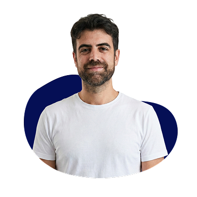 New Hampshire Man with dark hair and beard wearing a plain white t-shirt, standing in front of a white background with a blue abstract shape behind him. Marketing Agency