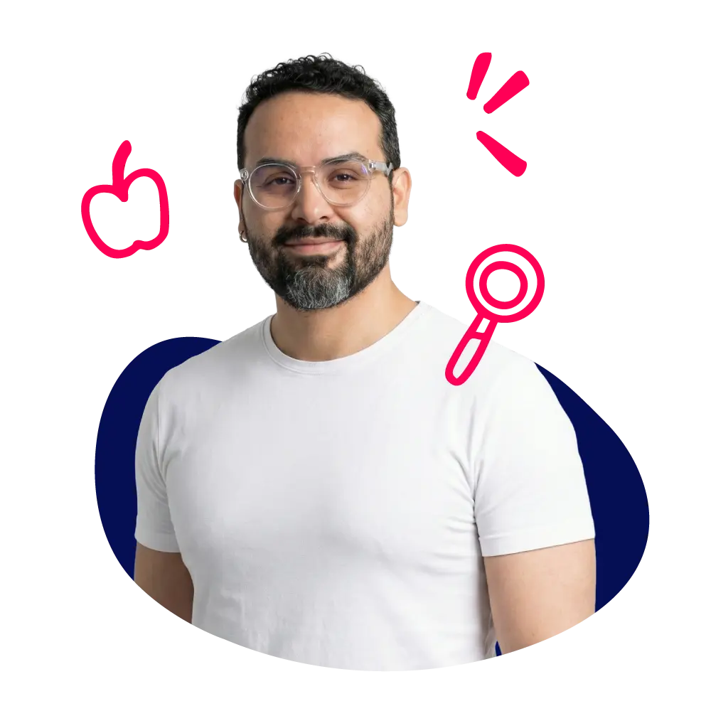 New Hampshire Man with glasses and a beard wearing a white t-shirt stands in front of a dark blue shape with red doodles of an apple, magnifying glass, and lines around him. Marketing Agency