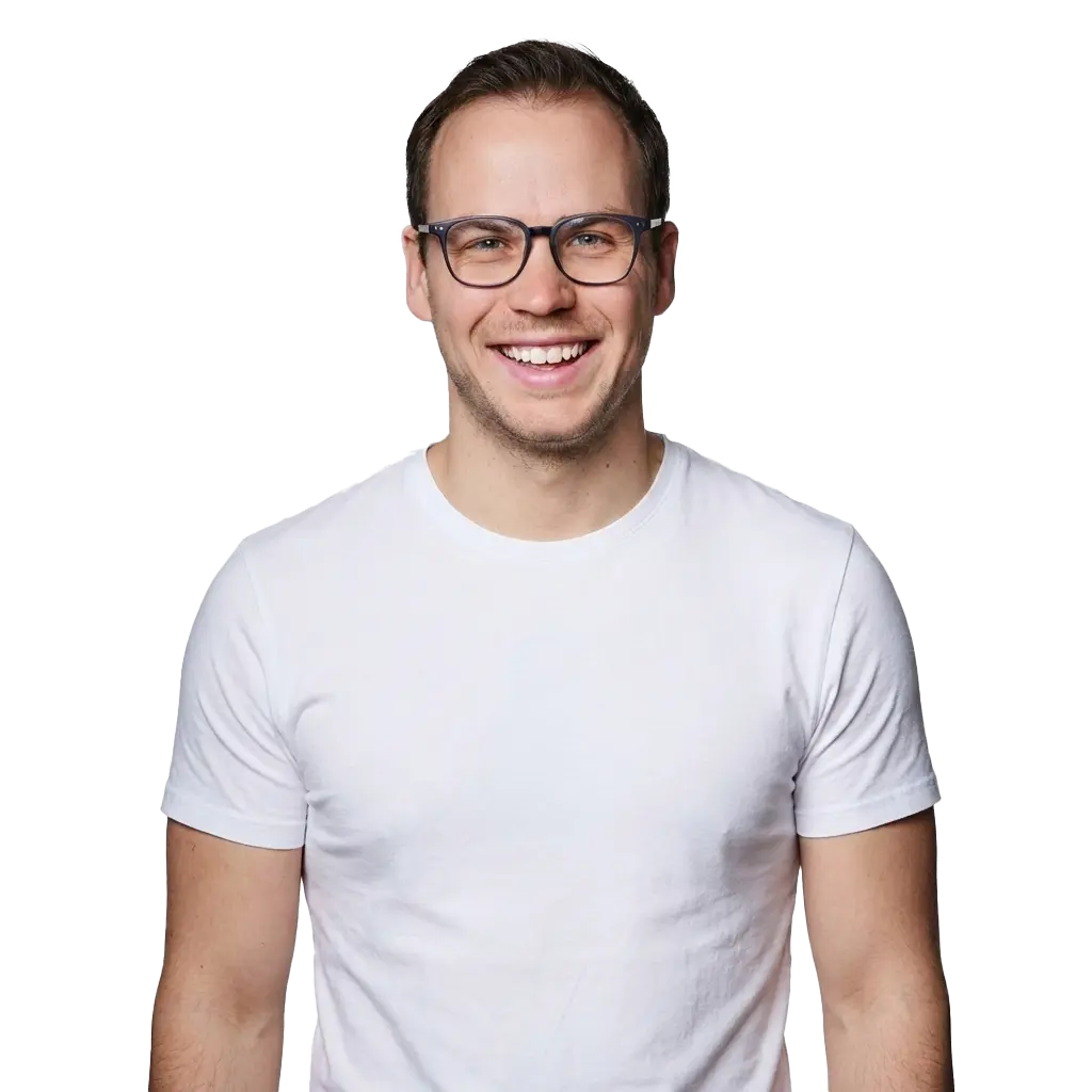 New Hampshire A man wearing glasses and a white t-shirt smiles at the camera against a plain white background. Marketing Agency